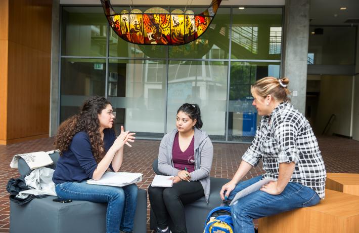 students talking in the rec center lobby