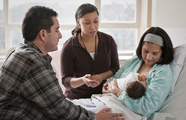 A new mother working with a lactation consultant