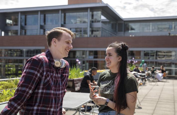 students talking on outdoor patio at rec center