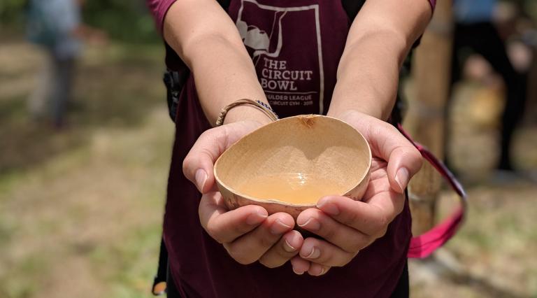 Person holding bowl of water