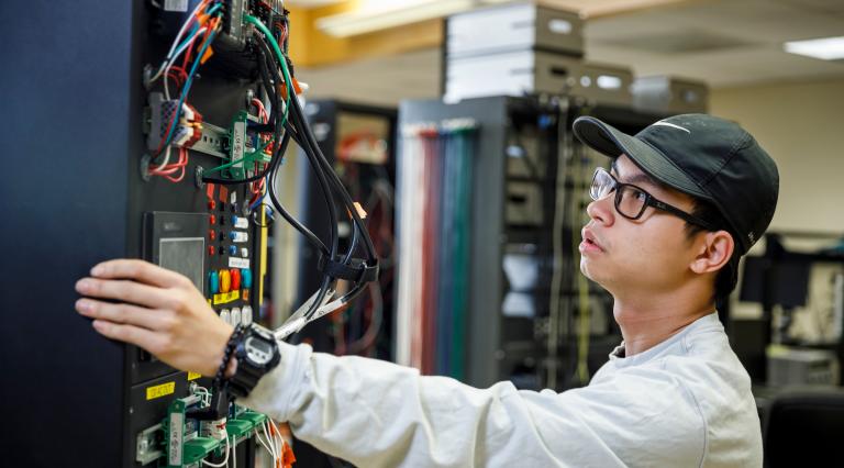 Student examining cables 