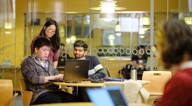 Students looking at laptop