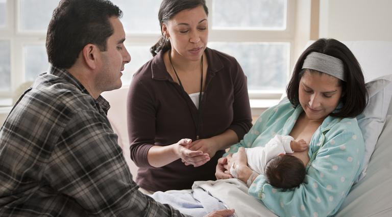 A new mother working with a lactation consultant