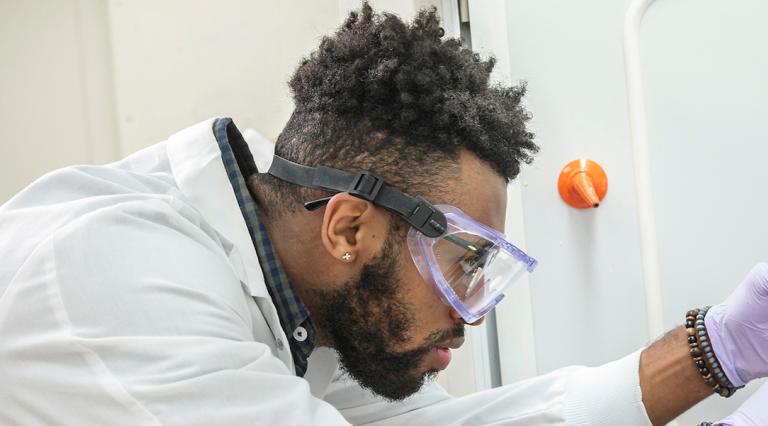 PSU community health student working in a lab