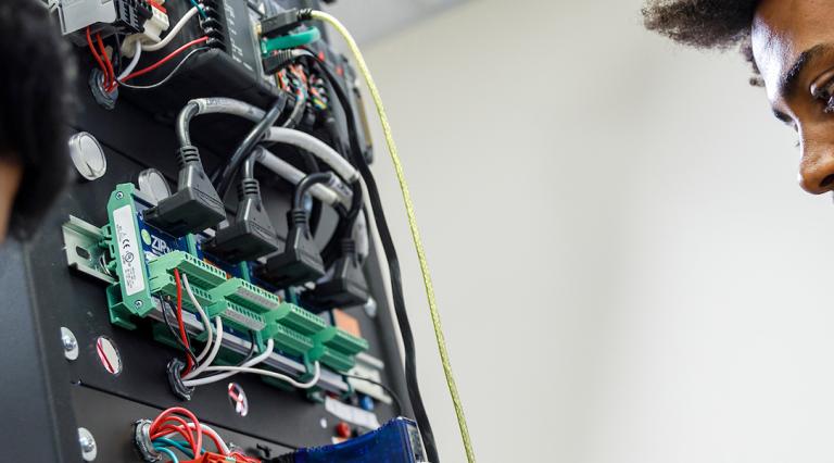 Two PSU Electrical Engineering students working in a lab