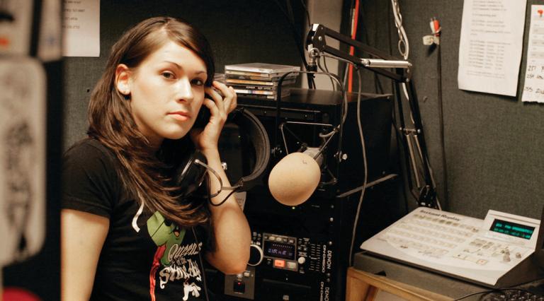 PSU student in the KSPU radio station broadcasting room