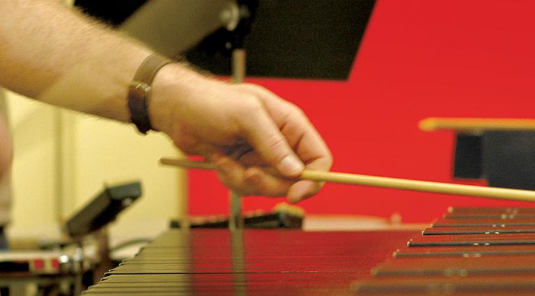 PSU music student performing on a xylophone