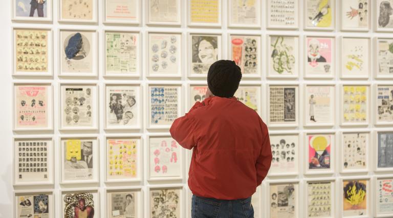 A Student looking at a wall of art