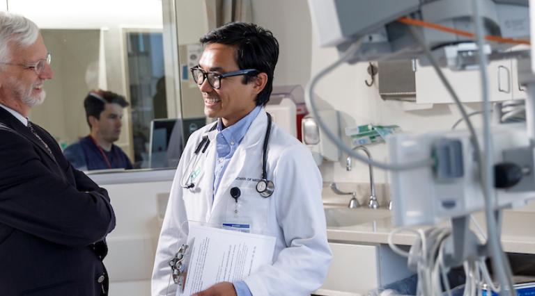 Two physicians speaking in a lab