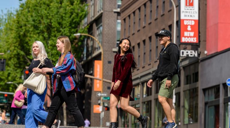 Four students crossing the street