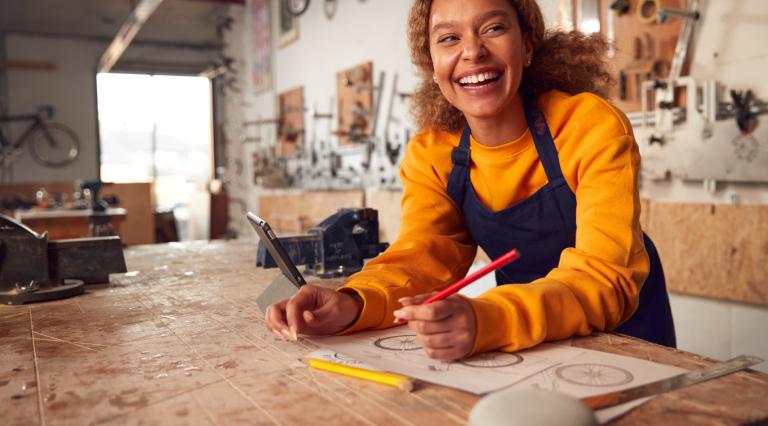 woman in bike shop wearing orange sweatshirt