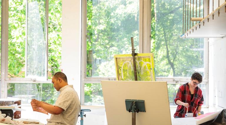 Students painting in an art studio.