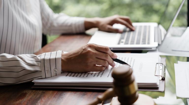 Student reading legal briefs at a computer