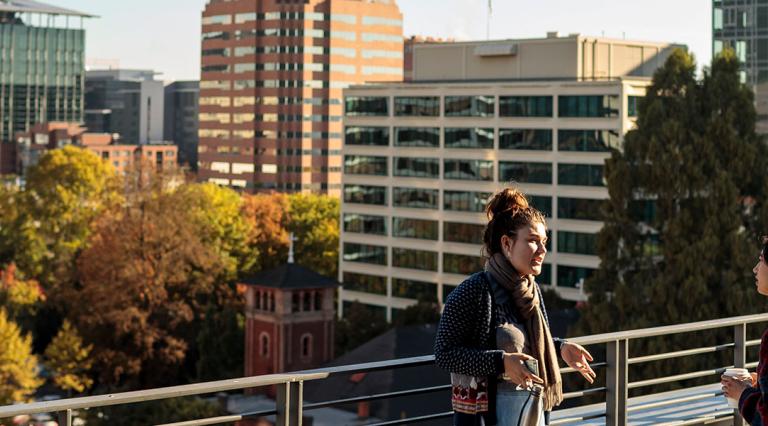 Students talking to each other on the 5th floor roof patio of ASRC