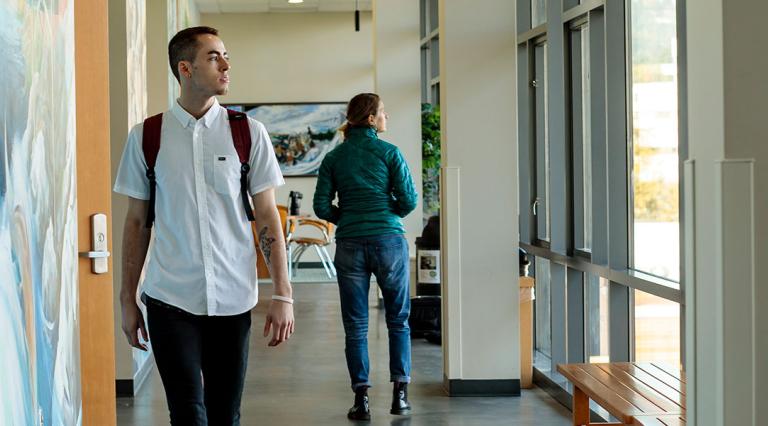 Student walking through the School of Social Work