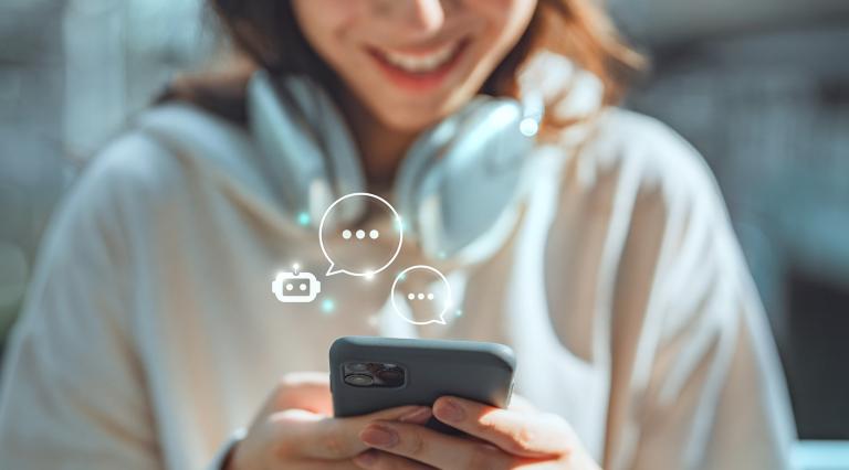 Person typing on their phone interacting with an AI chatbot