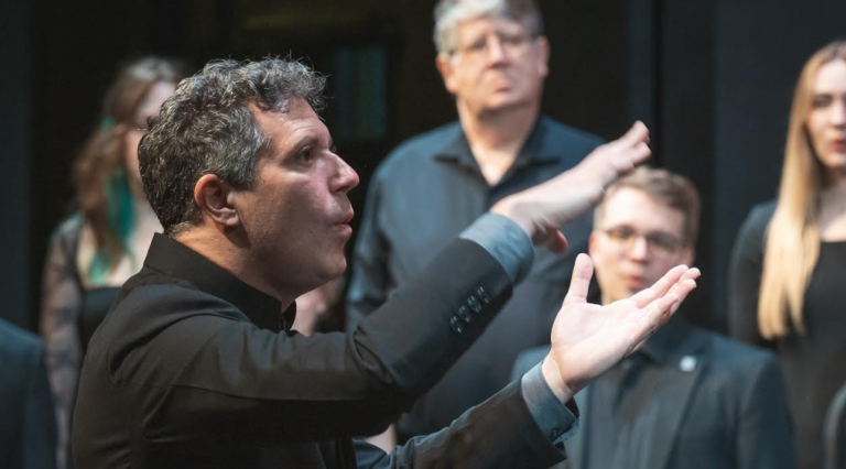 Ethan Sperry directing PSU's award-winning Chamber Choir