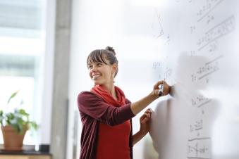 PSU graduate student teaching math to middle school students