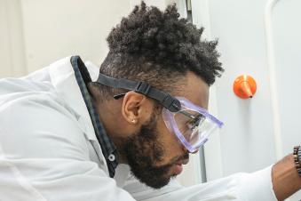 PSU community health student working in a lab