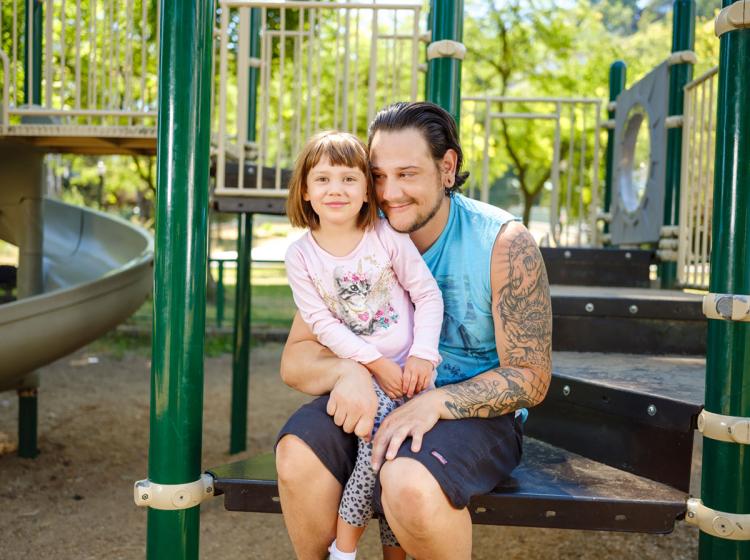 Student with a kid at a playground