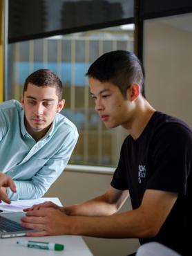  Two people working at a computer