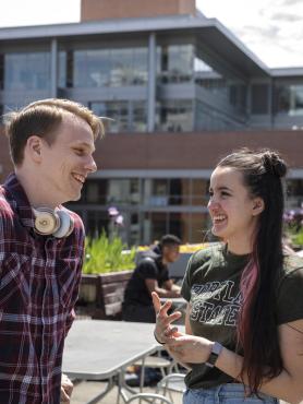 students talking on outdoor patio at rec center