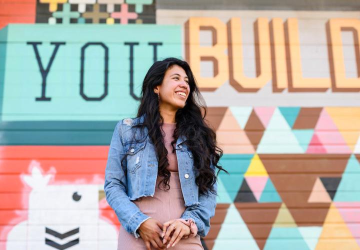 Student in front of mural