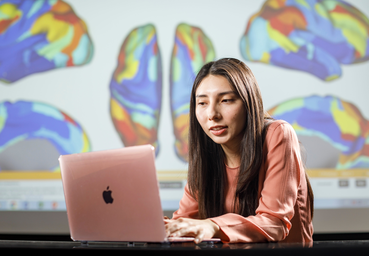 Woman in pink shirt at her laptop
