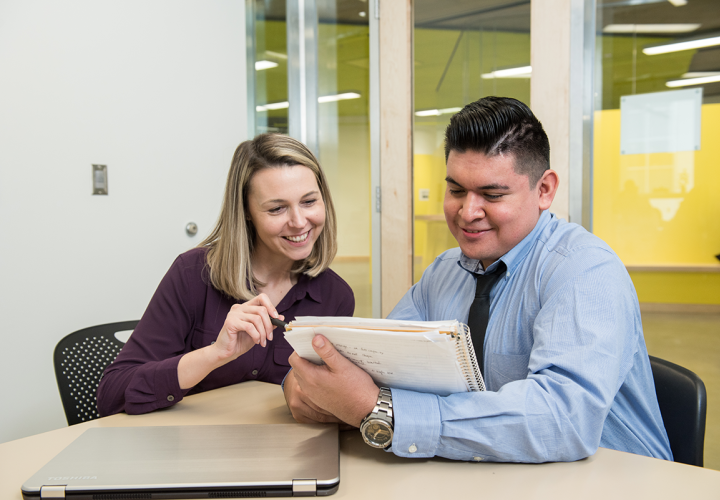 Two people looking at a paper