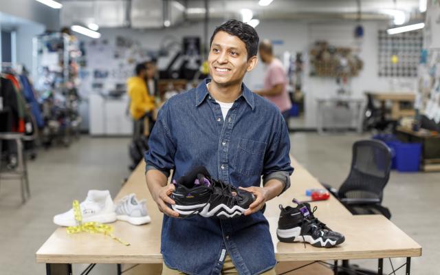 Man holding tennis shoe