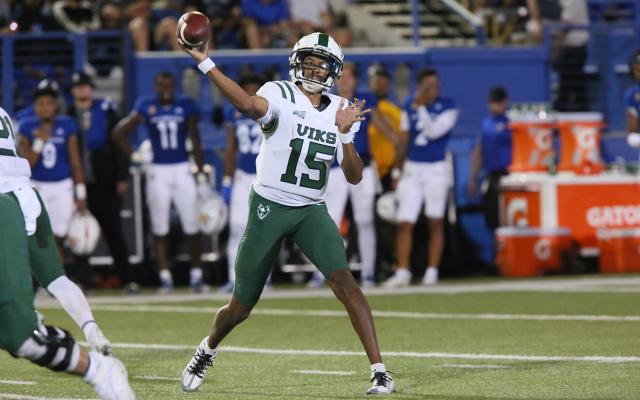 football player throwing a football