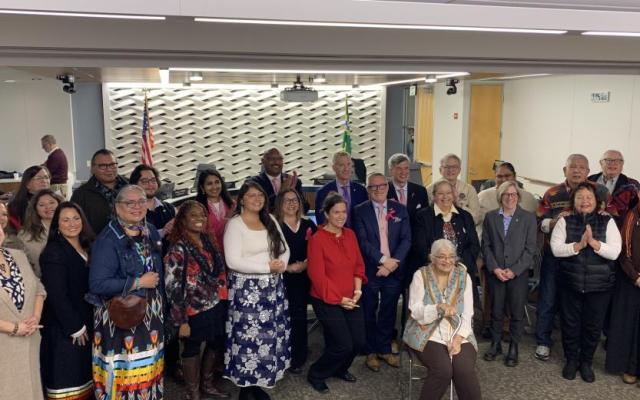 Rose Hill, seated at center, surrounded by family, friends, members of the Native community