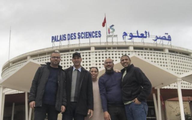 Madhu Narayanan (right), stands outside Palais des Sciences de Monastir in Tunisia with staff members Ahmad, Iyman, Najeh, and Ridha.