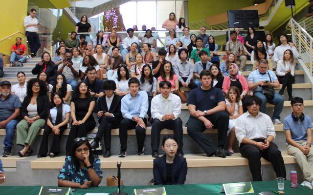 Group of high school students and guests seated on stadium-style steps during PSU’s 2025 Summer Business Institute pitch event