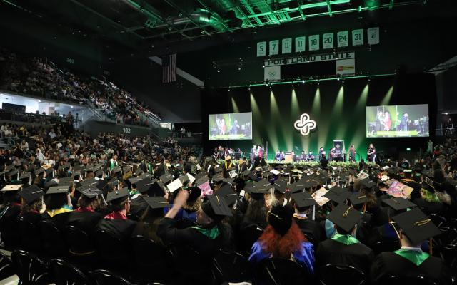 Portland State University graduates in caps and gowns during Commencement 2025 at Viking Pavilion