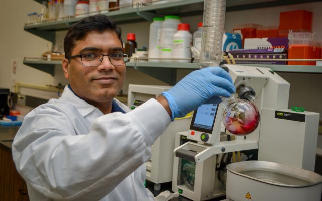 Papireddy Kancharla working in a Portland State University chemistry lab on malaria drug research