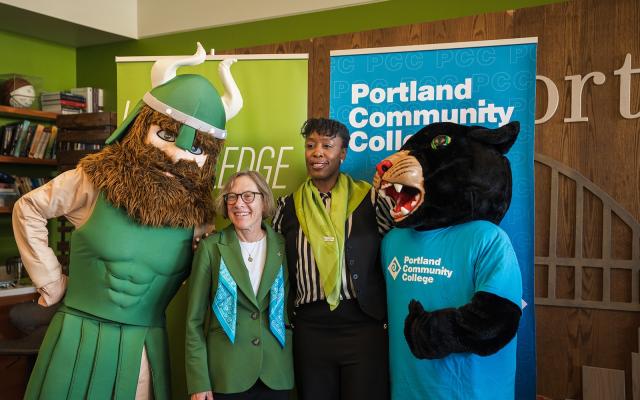 PSU President Ann Cudd and PCC President Adrien Bennings shake hands as campus mascots celebrate new partnership
