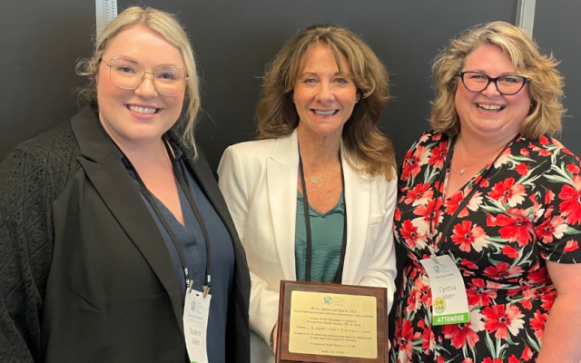 Shalene Allen, Leslie Hammer, and Cynthia Mohr accepting the Best Paper Award at the "Work, Stress and Health 2025" Conference on July 10, 2025