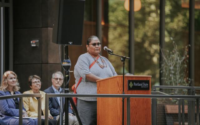 Modesta Minthorn, PSU’s inaugural executive director of Tribal Relations, speaks at a podium during the grand opening of the Vernier Science Center
