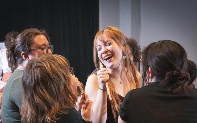 Student performer Evii Anderson sings with the cast of Spring Awakening during a rehearsal in Lincoln Hall