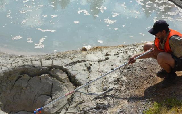 PSU researcher Ignacio de la Higuera collects samples from Boiling Springs Lake at Lassen Volcanic National Park