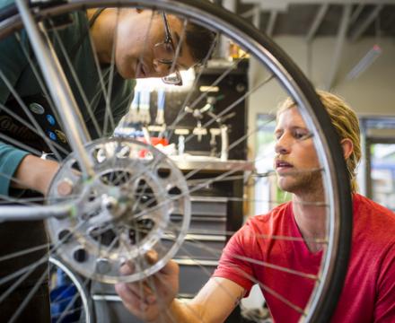 students working on a bicycle