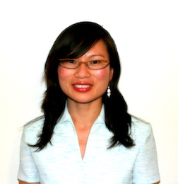Image of Liu-Qin Yang, a younger asian woman smiling at camera against white backdrop.