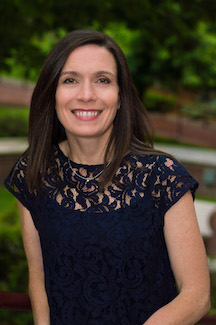 Image of Susanne Klawetter, a younger white woman with straight dark brown hair, smiling.