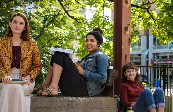 Three students listening to a lecture