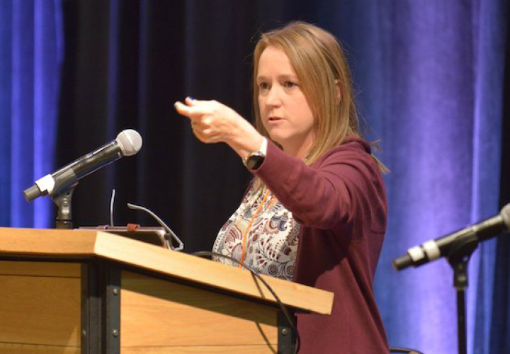 Photo of Mandy Davis (Director of Trauma Informed Oregon) at a podium