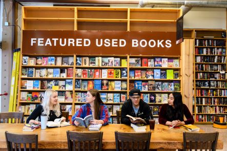 4 people sitting in a bookstore