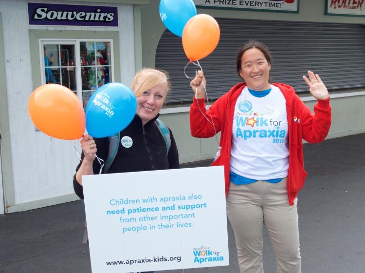 Two women holding balloons