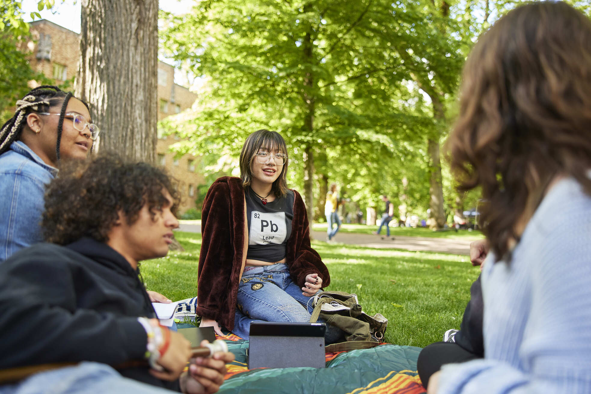 Students sitting on the grass and chatting in the Park Blocks