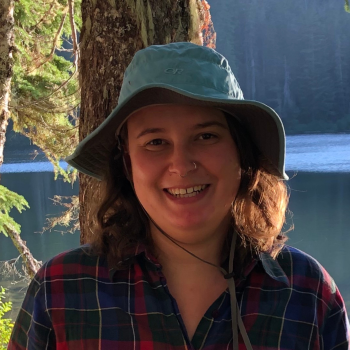 person wearing blue hat smiling at camera
